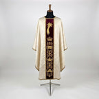 Front of an ivory damask Epiphany chasuble with a burgundy velvet column orphrey embroidered in gold with a comet star, a crown and roundels of the Magi's gifts