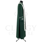 Side view of the forest green cassock robe showing the hip pocket marked with a silver crown and the cream yoke over the shoulder.