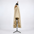 Side view of the ivory Franciscan chasuble showing the gothic drape and gold-toned lining