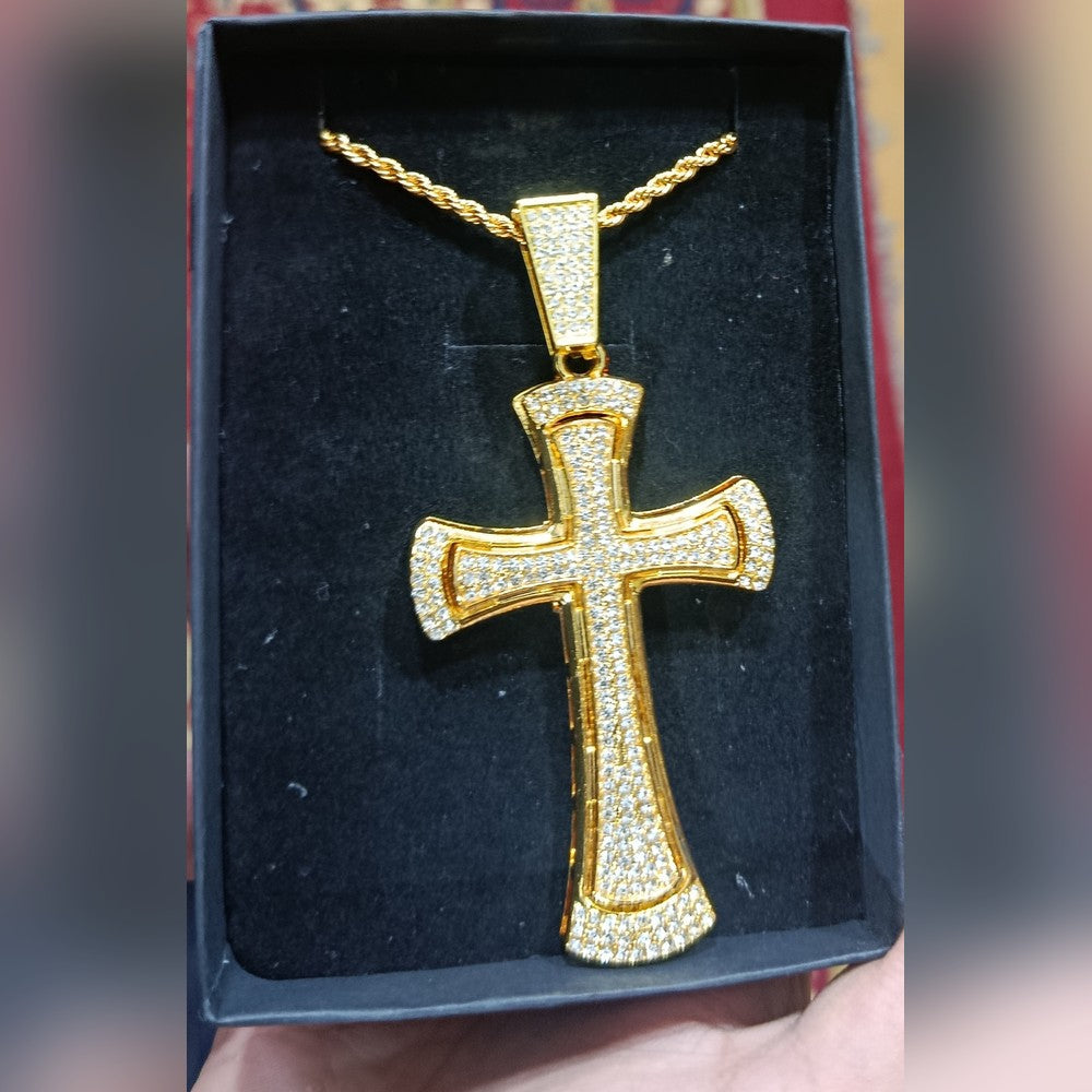 Gold-tone cross pendant set with pave clear stones, on a twisted rope chain, lying in a black gift box