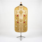 Back of the gold fiddleback chasuble with an ivory cross: radiant Nativity star, the manger, gold acanthus, red roses and white lilies
