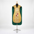 Front of a gold damask fiddleback chasuble with an ivory column embroidered with a star, red roses and a white lily, and green lining showing at the sides