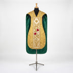 Front of a gold damask fiddleback chasuble with an ivory column embroidered with a star, red roses and a white lily, and green lining showing at the sides