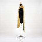 Side view of the gold fiddleback chasuble showing the open Roman cut and green lining