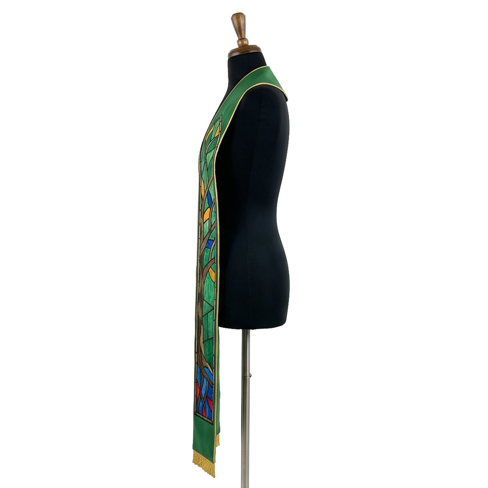 Close view of one green stole panel, showing the brown trunk, green leaf panes and gold-outlined stained-glass tree design.