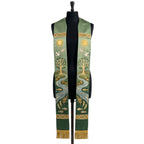 Green ombre stole on a mannequin, gold tree of life, river with fish and doves on both panels.