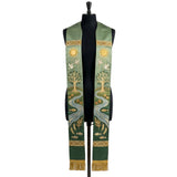 Green ombre stole on a mannequin, gold tree of life, river with fish and doves on both panels.