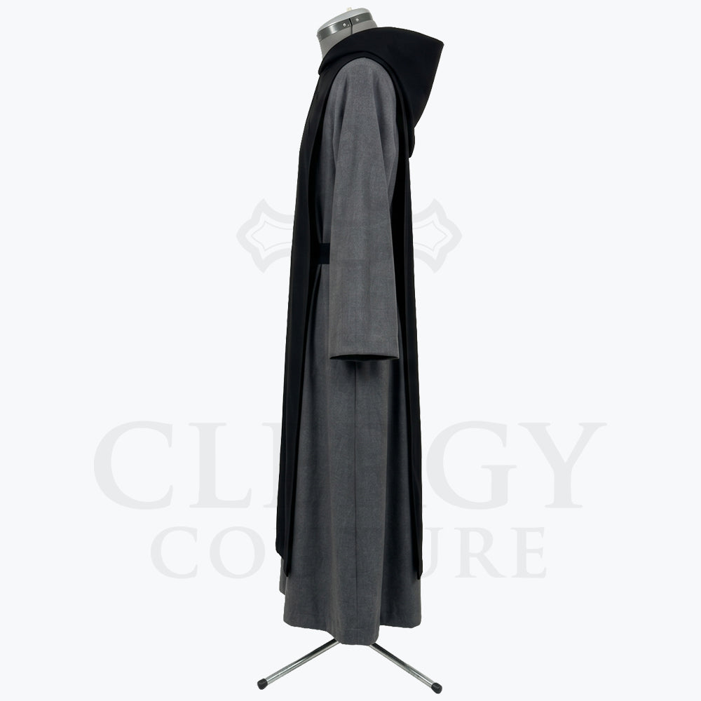 Side profile of the grey monk habit showing the black scapular layered over the tunic