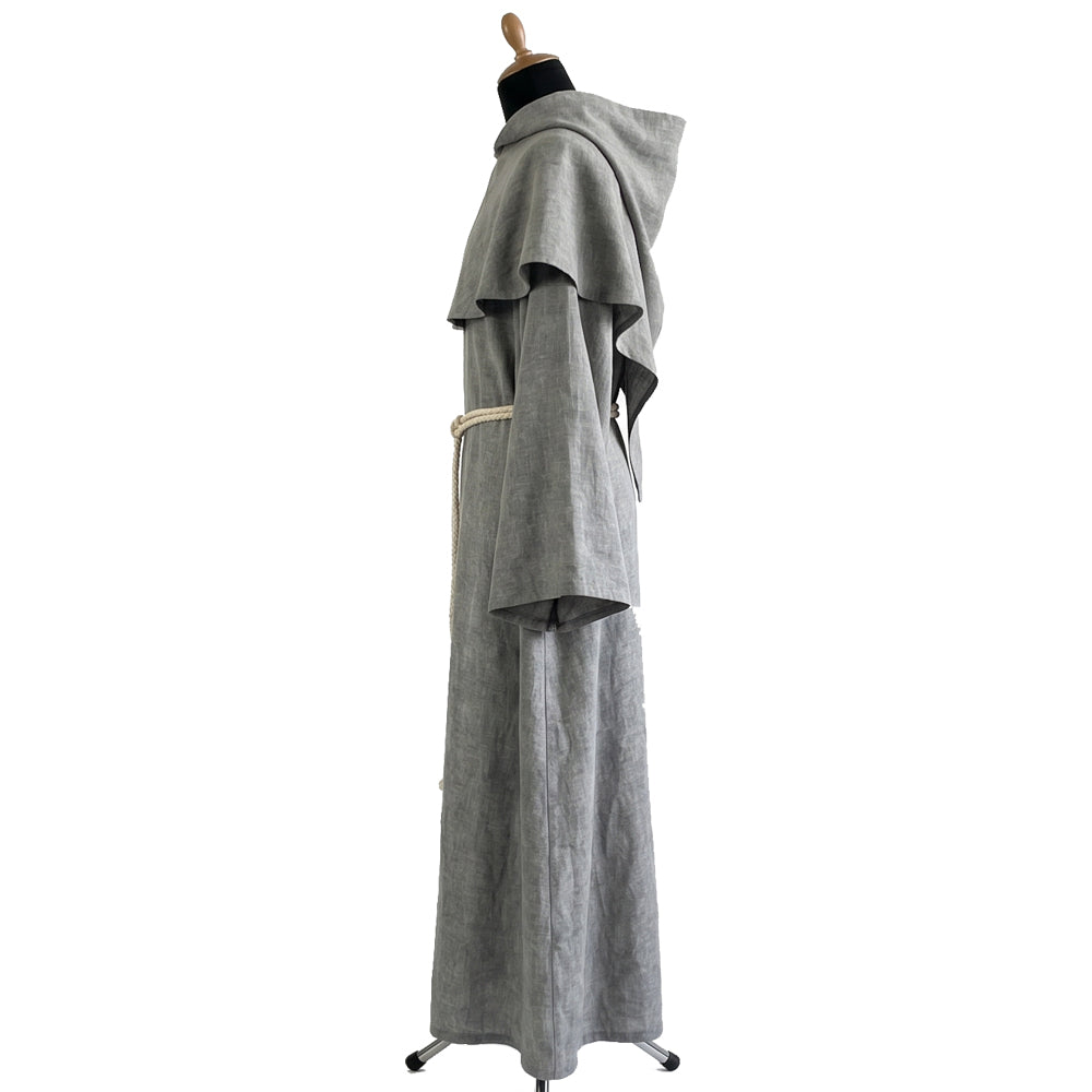 Side profile of the grey monk habit showing the capelet shape and raw-edge cuff detailing