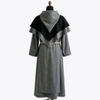 Back view of the grey habit showing the two-tier cape collar and plain skirt with a tan rope cincture.