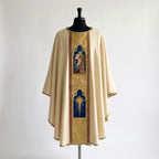 Front of an ivory chasuble with a gold damask column orphrey holding two arched panels: the Holy Family and the Star of Bethlehem