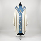 Back of the Immaculate Conception chasuble with a Y-shaped blue orphrey: lilies on the yoke, stars, a radiant sun, crescent moon and a lily vine ending in a white rose