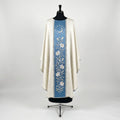 Front of an ivory damask chasuble with a Marian blue column orphrey: a silver crescent moon ringed by twelve stars above a vine of white lilies