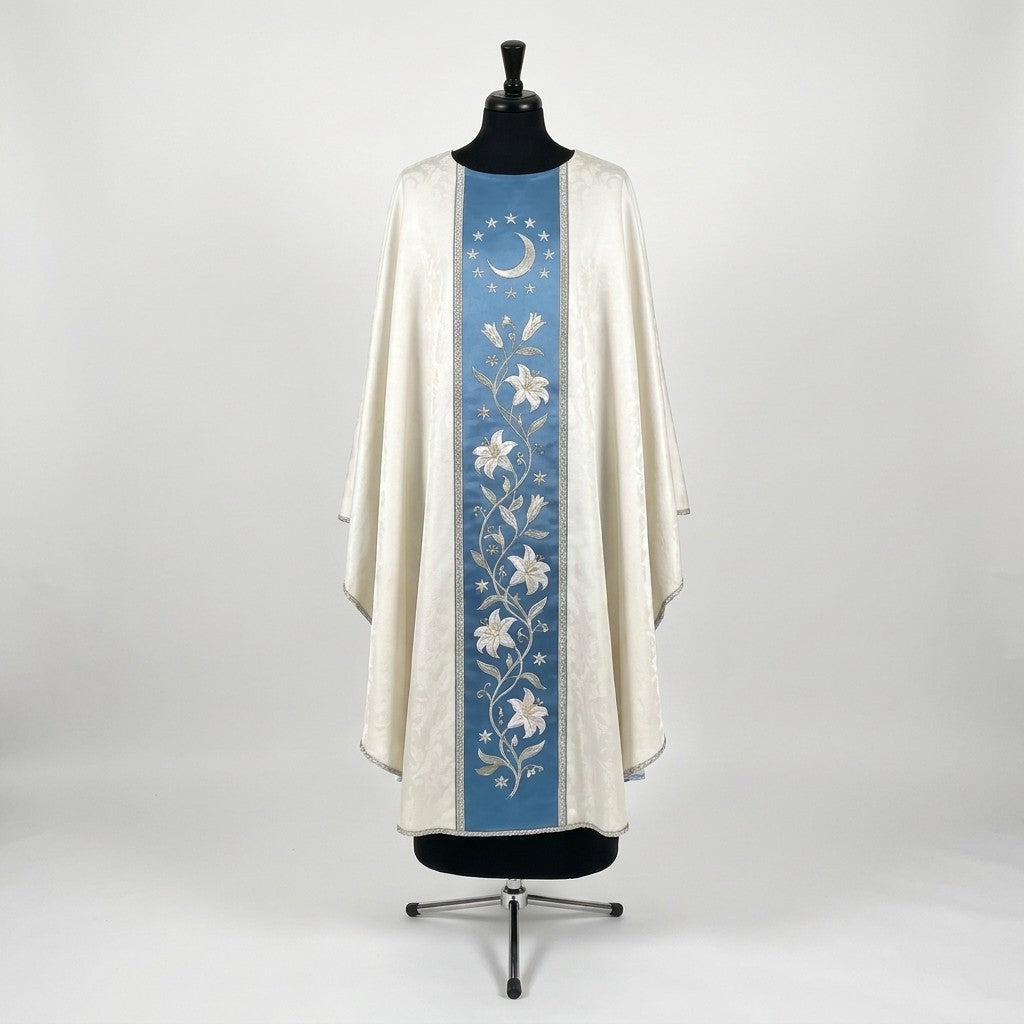 Front of an ivory damask chasuble with a Marian blue column orphrey: a silver crescent moon ringed by twelve stars above a vine of white lilies