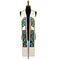Ivory clergy stole on a bust form, each panel showing an arched stained-glass tree over a glittering mosaic pattern.