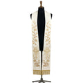 Ivory and gold clergy stole on a bust form, each panel showing a lily vine, Alpha and Omega letters and a radiating cross.