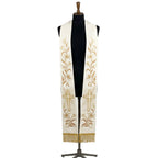 Ivory and gold clergy stole on a bust form, each panel showing a lily vine, Alpha and Omega letters and a radiating cross.