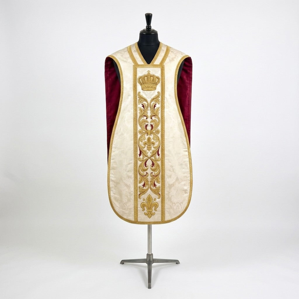 Front of an ivory damask fiddleback chasuble with a gold column orphrey: a crown, acanthus scrolls and a fleur-de-lys, showing the crimson lining at the sides