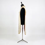 Side view of the ivory fiddleback chasuble showing the open Roman cut and the crimson lining