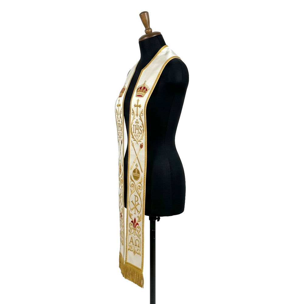 Close view of one panel on the ivory stole, showing the crown, cross, IHS monogram and crossed torches in gold thread.