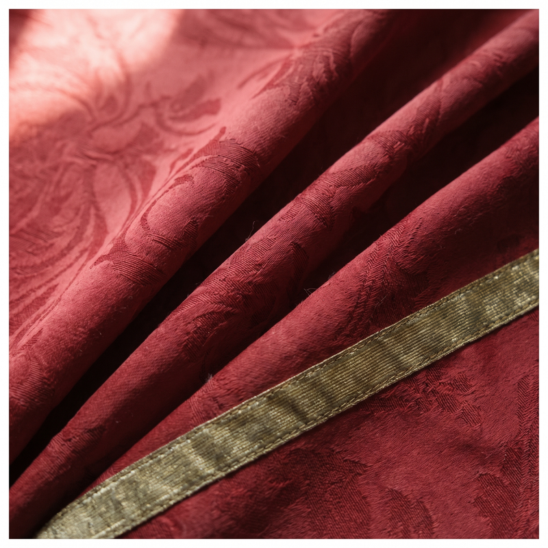 Close detail of deep cardinal red silk damask with gold trim, the liturgical colour of Pentecost and the martyrs