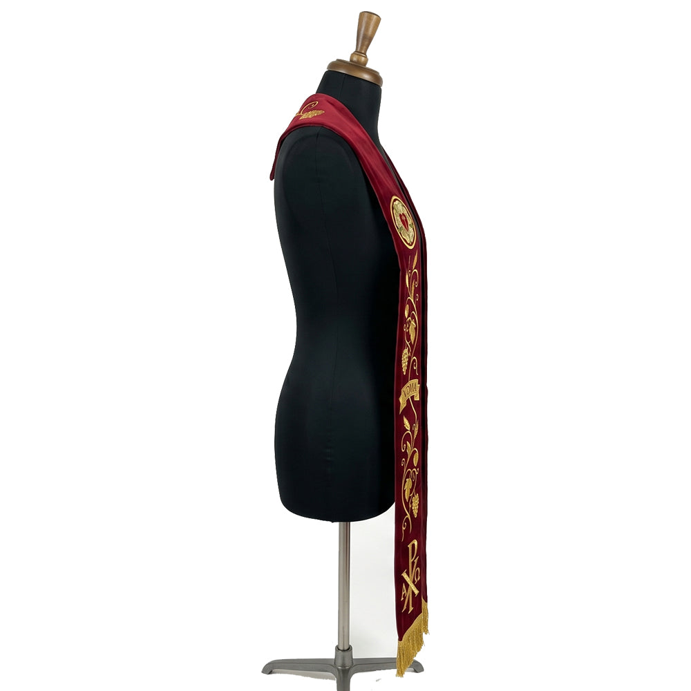 Close-up of the Luther Rose medallion and VDMA banner embroidery on the burgundy Lutheran Stole.