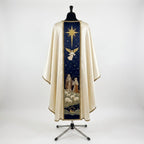 Back of the Nativity chasuble with a navy orphrey: the Star of Bethlehem, an angel, two shepherds with sheep and the stable of Bethlehem at the hem