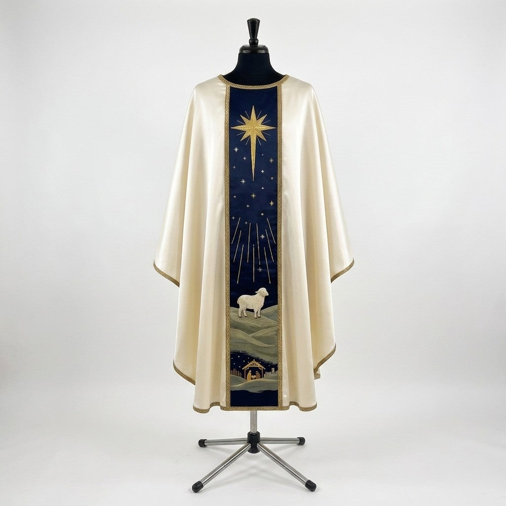 Front of an ivory satin Nativity chasuble with a navy column orphrey: a gold star with long rays above a white lamb on green hills and the stable at the hem
