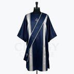 Navy blue satin dalmatic with silver bands and a silver cross at the breast, front view with the matching deacon's stole worn across the body