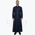 A pastor wearing the navy blue clergy cassock robe, front view, showing the stand collar and the sash belt with tassel.