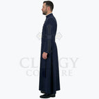 Side view of the navy blue cassock robe worn by a model, showing the sash tie and the fall of the skirt.