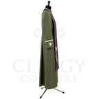 Side view of the olive green cassock robe showing the plum stole hanging past the hip and the dove-marked pocket.
