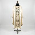 Front of an ivory satin Christmas chasuble with a column orphrey of a holly wreath round a gold star, blush poinsettias, holly and red berries