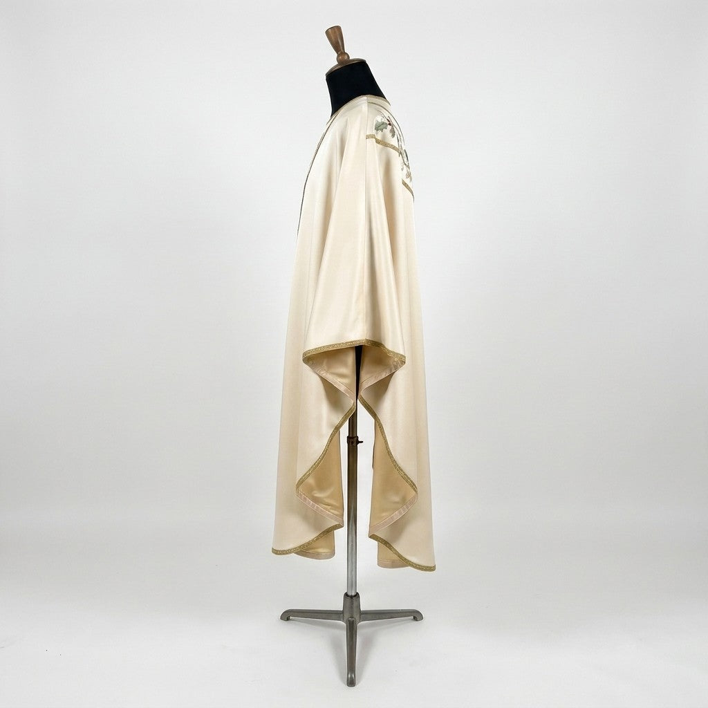Side view of the ivory satin poinsettia chasuble showing the gothic drape and ivory lining