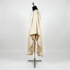 Side view of the ivory satin poinsettia chasuble showing the gothic drape and ivory lining