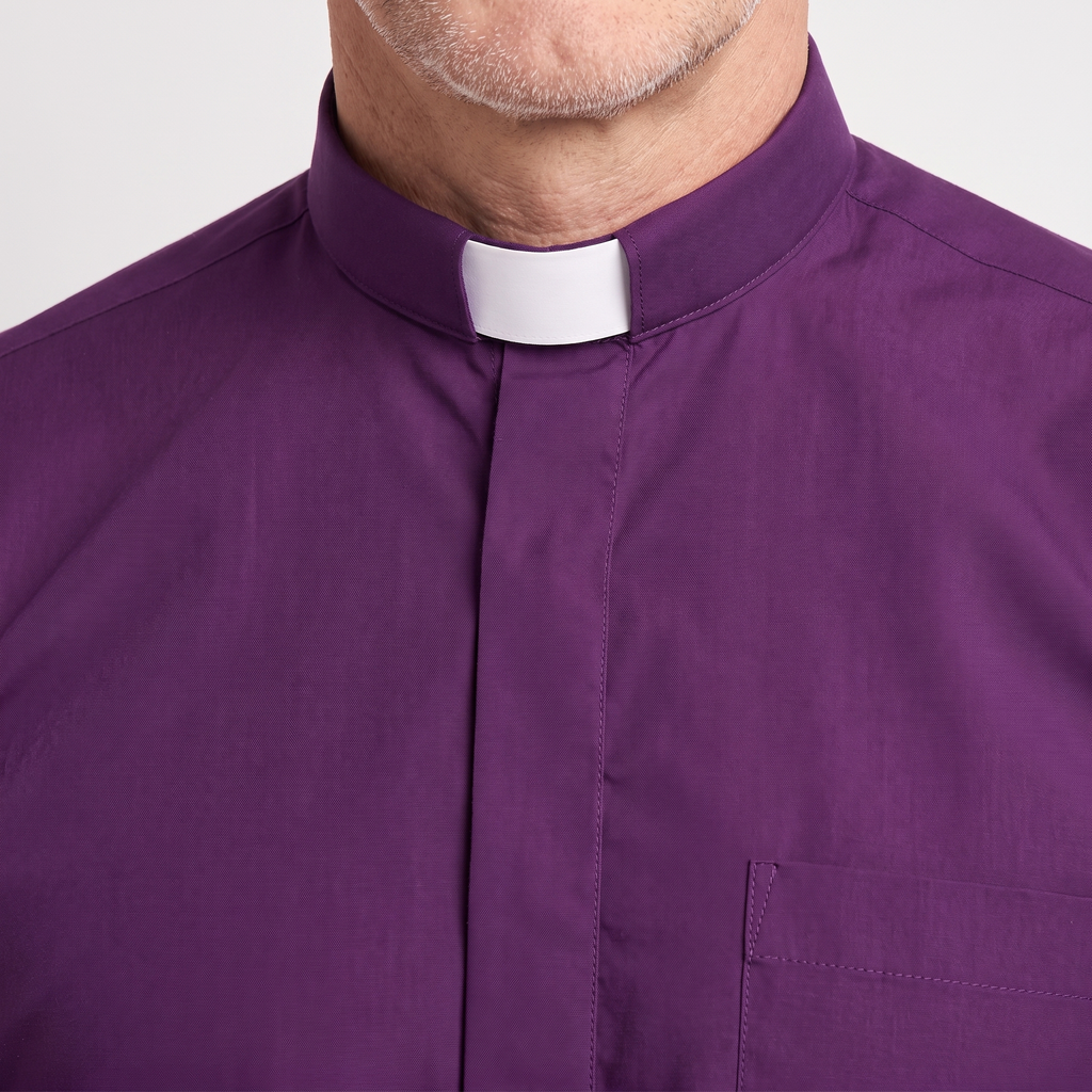 Close-up of the tall purple tab collar with a white tab, the covered button placket and the top of the chest pocket.
