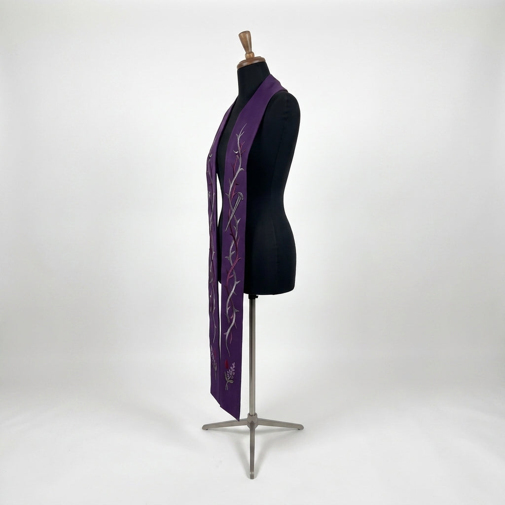 Close-up of the thorn vine and nail embroidery on the purple Lenten Stole's plain satin panel.