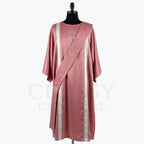 Rose satin dalmatic with silver bands and a slender silver cross at the breast, front view with the matching deacon's stole worn across the body