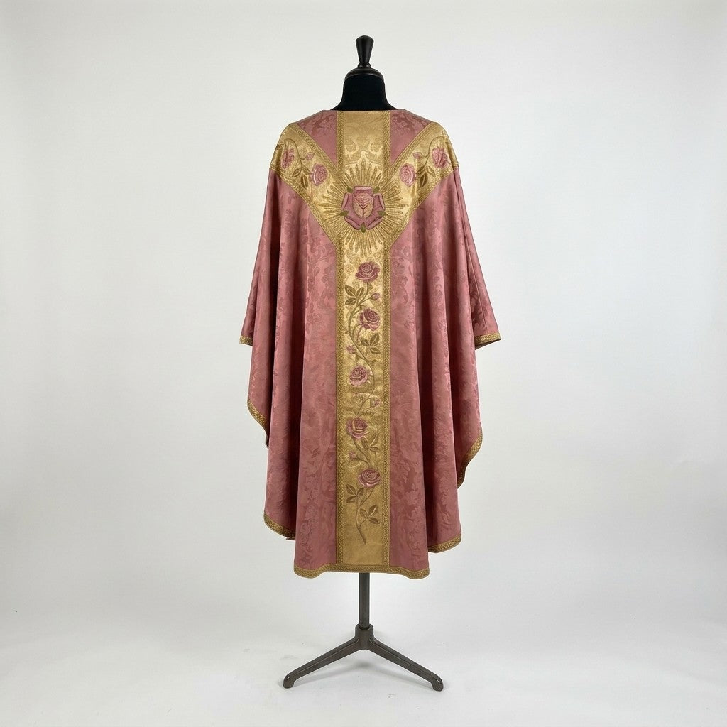 Back of the rose Gaudete chasuble with a Y-shaped gold orphrey: a heraldic rose and cross in gold rays, rose sprays across the yoke and a rose vine down the column