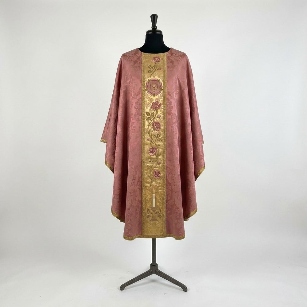 Front of a rose damask chasuble with a gold column orphrey: a heraldic rose bearing a cross, a climbing rose vine and a lit candle at the hem