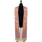 Rose stole on a mannequin, cream and blush rose vine with a radiant gold cross embroidered on both panels.