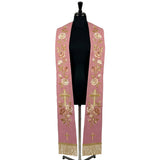 Rose stole on a mannequin, cream and blush rose vine with a radiant gold cross embroidered on both panels.