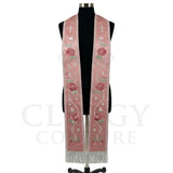 Rose pink striped stole on a mannequin, silver cross, star ribbon trail and roses on both panels.