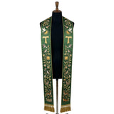 Green stole on a mannequin, Tau cross, birds and woodland animals embroidered down both panels.