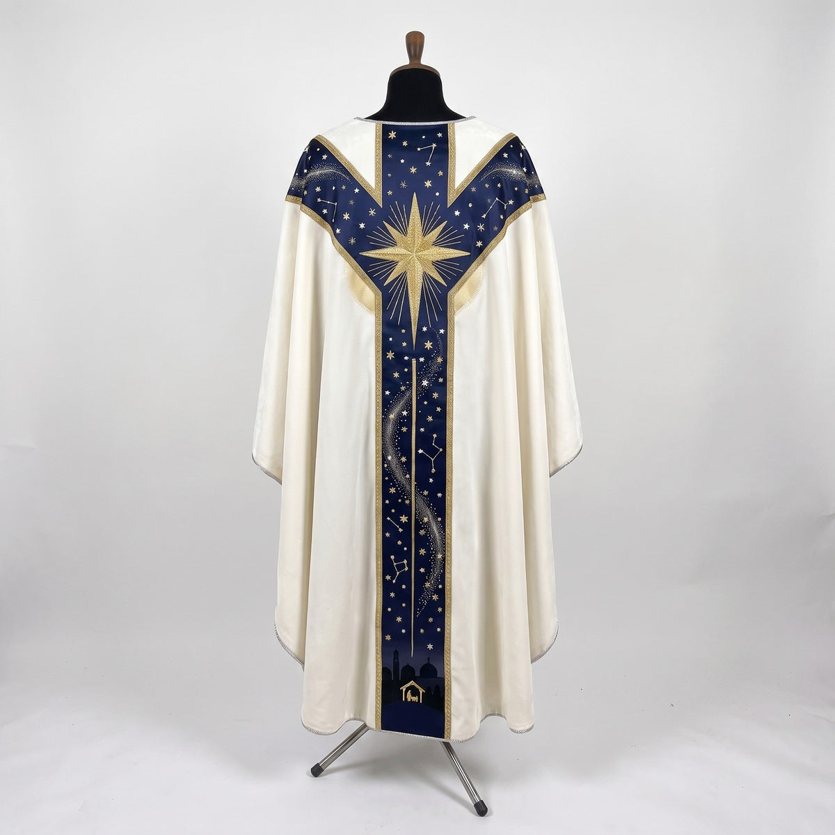 Back of the Star of Bethlehem chasuble with a Y-shaped navy orphrey: a large radiant gold star across the yoke, starry sky and the town of Bethlehem at the hem