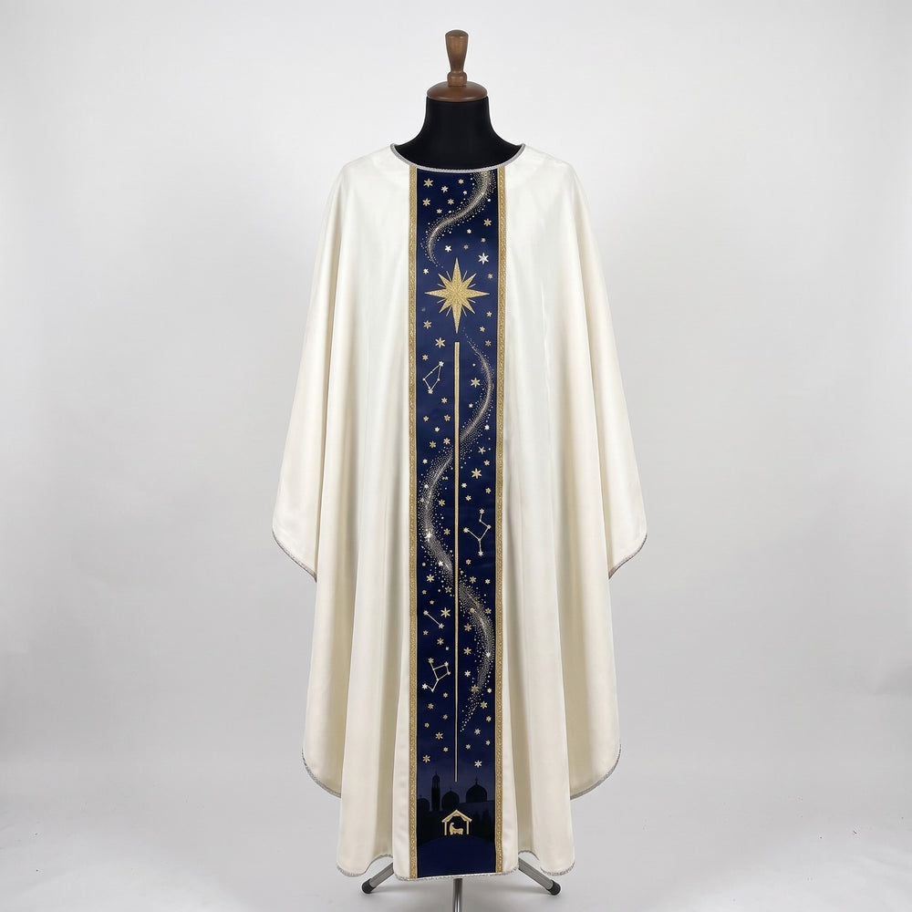 Front of an ivory chasuble with a navy column orphrey: a gold eight-pointed star, constellations, a silver trail of light and the Bethlehem skyline with the stable at the hem