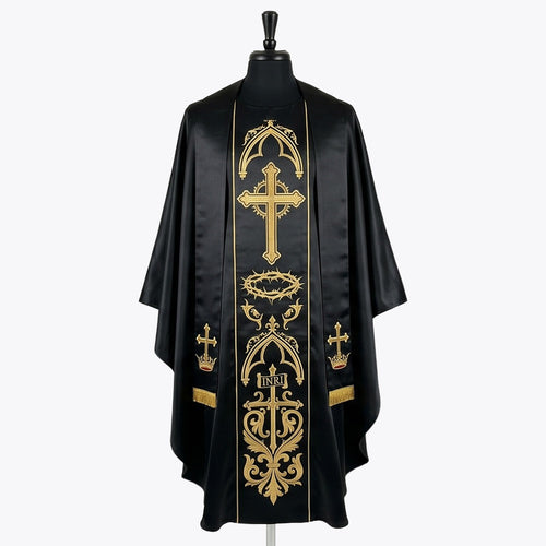 Front of a black gothic chasuble, the gold orphrey embroidered with a flowering cross, a crown of thorns and an INRI cross, shown with a matching black and gold stole
