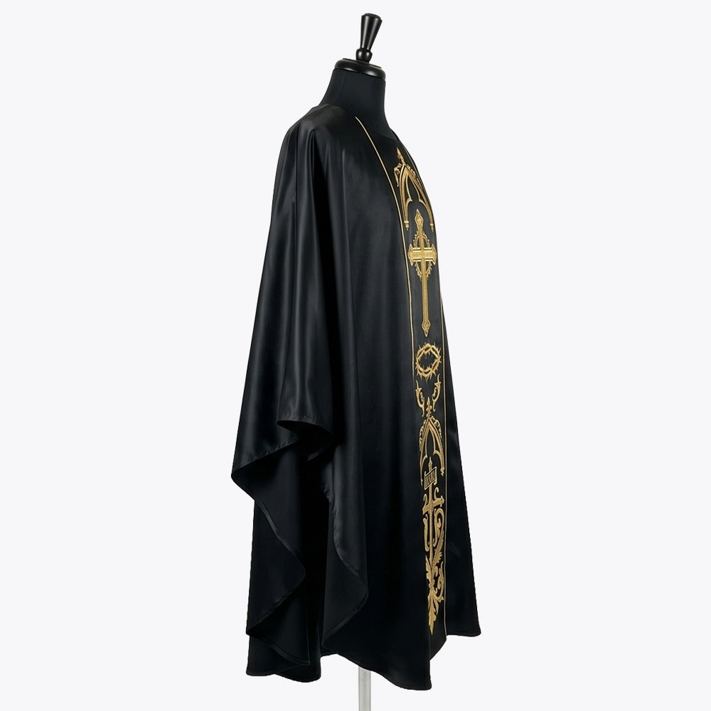 Side view of the black satin chasuble showing the full gothic drape falling over the arm
