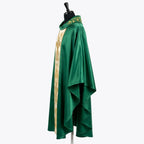 Side view of the green satin chasuble showing the embroidered standing collar and the gothic drape over the arm