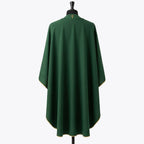 Plain green back of the chasuble with a small gold cross at the collar and gold piping along the hem